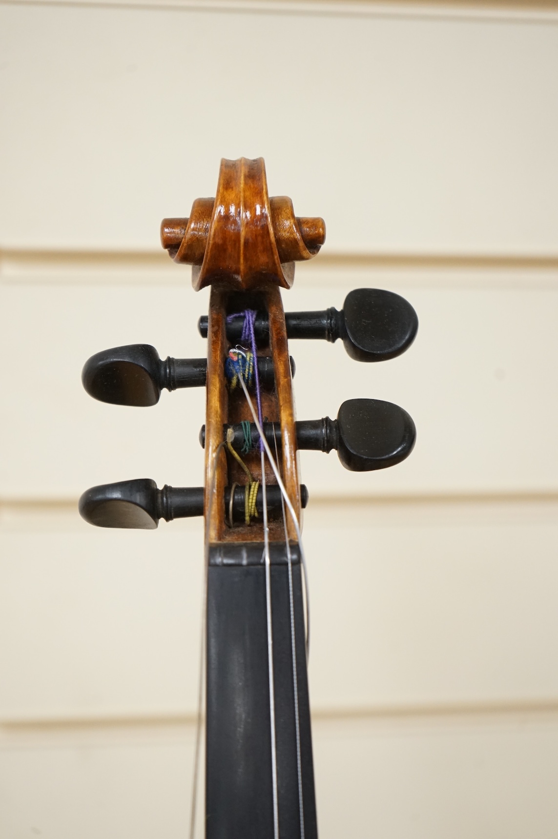 Three violins; a late 19th century German Stradivarius pattern violin, without label, a handmade violin (a.f.), with sound post crack, broken and repaired scroll, etc. and a Maidstone violin body, varnish stripped from t